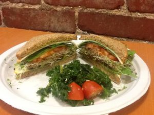 Vegetarian powerhouse sandwich on Ezekiel bread with a raw vegan, gluten-free kale salad side. at Superfoods Cafe & Market in Mt Airy