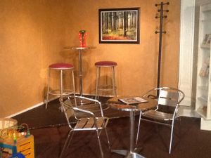 Store side has a stage where open mic night and some classes are held. When not in use for those events, is a nice seating area. In the bottom left, you can glimpse a child's toy from the children's play area. Perfect place for moms. at Superfoods Cafe & Market in Mt Airy