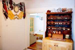 Kitchenette for The Room with Flowers, traditional Transylvanian design 'Rod-Marginimea Sibiului', authentic ceramic plates, wood cutlery, tap water from natural spring at Copacul Vietii in Sibiu