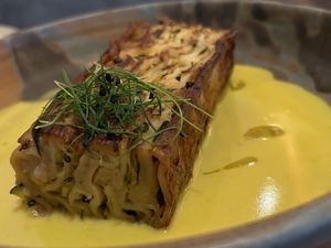 zucchini lasagna bianca: pan-finished, served with roast garlic & lemon cream, truffle oil   at Mallow - Canary Wharf in East London