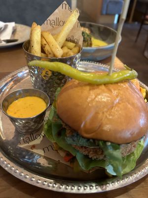 mallow house burger: signature fried plant chick+n, amba pickle glaze, roast pepper taktouka, pimento mayo, brioche bun, pickles, lemon pepper fries  at Mallow - Canary Wharf in East London