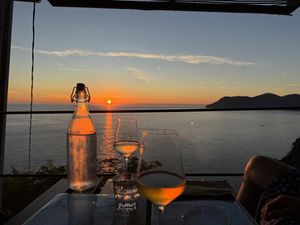 Sun set from our table with local white wines .  at Marina di Corniglia Bar in Corniglia