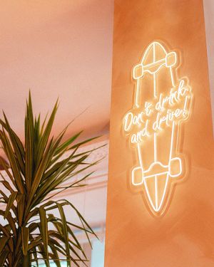 Fresh looking skateboard neon sign hanging on the wall at Hulala in Dusseldorf