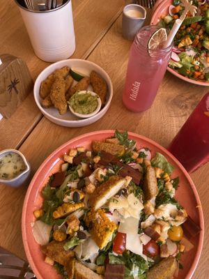 Our dishes: Caesar salad and chicken wings   at Hulala in Dusseldorf