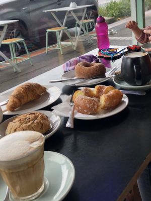 Bonsoy latte, chocolate chip cookie, croissant, glazed and cinnamon broduts, and a cappuccino. at Mister Nice Guy's Bakeshop in Ascot Vale