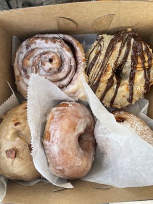 Cinnamon roll, Samoa donut, maple bacon donut (w/ coconut bacon), classic glazed, and strawberry jelly filled  at Sweet Theory Baking Co. in Jacksonville