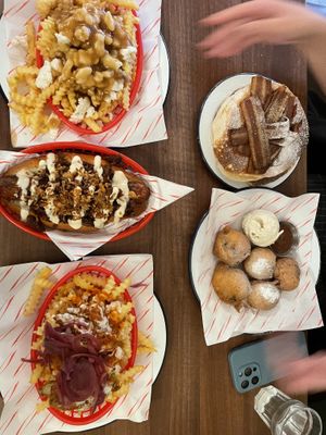 left: poutine fries, smokin’ dog, buffa-loaded fries. right: pancakes with bacon, deep fried oreos   at Dimpsy's Diner in Plymouth