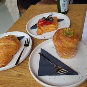 Vegan croissant, strawberry tart and pistache cruffin at Crave Coffee & Bakery in Rotterdam