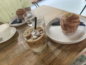 Iced oat latte and pistachio cruffin  at Crave Coffee & Bakery in Rotterdam
