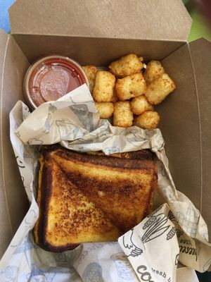 Classic vegan grilled cheese with marinara sauce and tater tots  at I Heart Mac & Cheese - Woodfield Mall in Schaumburg
