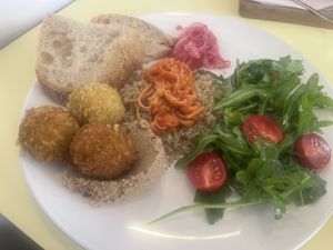 Vegan breakfast included toasted bread, whipped tofu spread, pickled onions, falafels, quinoa with enoki mushrooms and side salad  at Kultura Diktuet in Astana