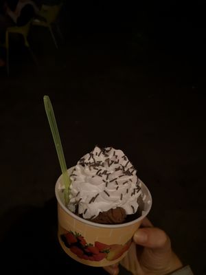 A kids portion of chocolate ice cream with vegan whipped cream at Kiez & Kugel in Berlin