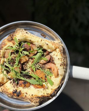 Peach Preach Pizza with cashew sauce, grilled peaches, homemade fatty soy mince, Armenian capers, arugula at Nagotove - Наготове in Moscow