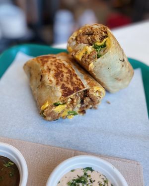 Our vegan Sunrise Burrito: Just Egg, Violife “cheddar” cheese, Uncut vegan sausage & hash browns. (No longer served with arugula) Comes with our Vegan chipotle rosemary aioli! at Whale Bites Cafe in Depoe Bay
