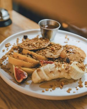 Gluten free buckwheat pancakes with seasonal fruit, chocolate sauce, and homemade granola at botànic in Barcelona