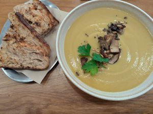 Cream of vegetable soup with toasted sourdough bread at botànic in Barcelona