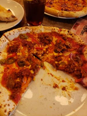 (I got too excited and started before taking a pic) create your own 12" . Mine had vegan cheese, red sauce, jalapeños, sweetcorn, red pepper, red onion, sundried tomatoes, nduja a at Pizza Punks in Liverpool