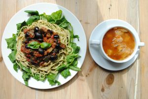 Cabbage soup and spaghetti with basil pesto, sauce made from aubergine, zucchini, olives and tomatoes with fresh spinach. at Vega in Wroclaw