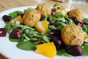 Salad with tahini sauce - spinach, rucola, baked beetroots, pieces of orange, almonds, tofu balls, tahini sauce. at Vega in Wroclaw