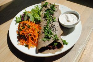 Buckwheat pancake with lentil&beetroot filling. Buckwheat pancake stuffed with green lentils, baked beetroot and coconut milk. Seasoned with cummin and chilli. Served with coconut dip and salads. Gluten­free. at Vega in Wroclaw