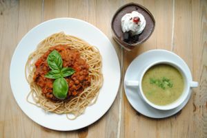 Zucchini cream and spaghetti with lentils sauce, tomatoes and  grilled vegetables. Pudding made from cocomilk and vegan jelly and chocolate mousse. at Vega in Wroclaw