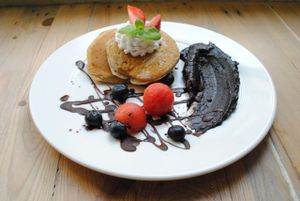 Pancakes with fruits and dactylla. Fluffy banana pancakes. Served with nut&dactyl paste and fresh seasonal fruits. Gluten-free available. at Vega in Wroclaw