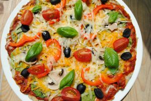 Vegan Pizza with vegetables: traditional pizza with tomato-herb sauce, vegan cheese and three additives olives, mushrooms, sun-dried tomatoes, spinach, peppers, broccoli, zucchini). at Vega in Wroclaw