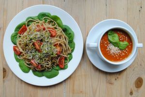 Tomato-aubergine soup and spaghtetti with olive-orange pesto, spinach, cherry tomatoes. at Vega in Wroclaw