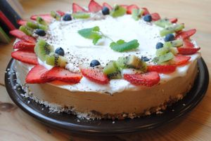 Unbaked vanilla tofucake with nutty base, coconut whipped cream and fruits. at Vega in Wroclaw