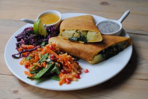 Indian dosa with coconut-fenugreek chutney and mango-date sauce with and salad. at Vega in Wroclaw