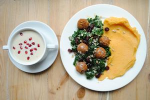 Cauliflower-tahini cream-soup and potato-carrot puree with tofu-millet balls with herbs, kale and cranberrys. at Vega in Wroclaw