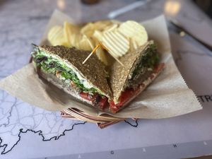 Athena’s Gift- Raw, gluten-free vegan sausage topped with cashew cheeze spread, spring mix, olive salad, and tomatoes. Served with chips and a pickle spear.   at European Street in Jacksonville