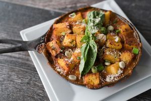 crispy polenta skillet: local herbed crispy polenta baked on a bed of marinara sauce, squash, greens, onions, broccoli, local mushrooms
(dinner menu)  at Zest Kitchen & Bar in Salt Lake City