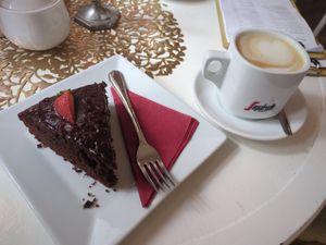 Chocolate cake and oat milk cappuccino at Barbarella Cafe in Aachen