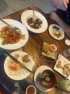 Forgot to take a picture until we started eating but starting from the left clockwise: sweet and sour pork, kung pao chicken, crab cake, lions mane popcorn chicken, miso soup   at Clover Plant Based Kitchen & Bar  in Central Singapore