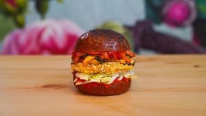 Beetroot bun with poppy seeds, aubergine patty, grated peppers, iceberg lettuce salad, roasted cherry tomatoes sauce, basil at Green M'ama in Naples