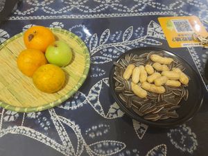 Fruit, peanuts, sunflower seeds and barley (?) brought to the table, included in the meal price.  at Yún Shān Zhī Jùn 雲山之菌 in Dali