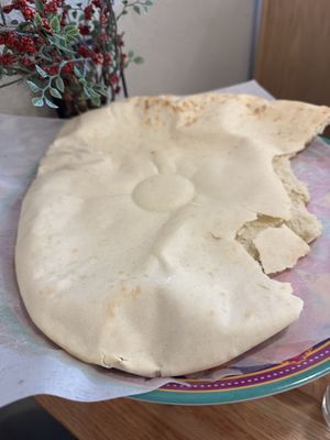 Huge, hot, smoking pita with spices in oil    at Nicholas Restaurant in Gresham