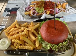 Burger and loaded fries with guacamole salsa kidney beans corn and onions  at HighFive in Winterberg