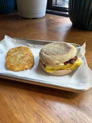 English muffin, tofu egg, cheese, and crispy bacon with a hash brown patty  at Brunch Box in Springfield