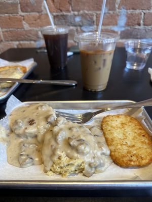 Biscuits and gravy with a hash brown patty. The coffees in the background have coffee ice cubes!  at Brunch Box in Springfield