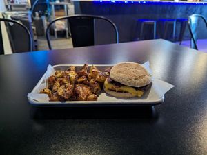 Tofu bacon breakfast sandwich on an English muffin. With potatoes at Brunch Box in Springfield