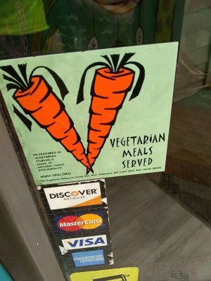 Sticker on door "Vegetarian meals served"  at Tricky Fish in Charleston