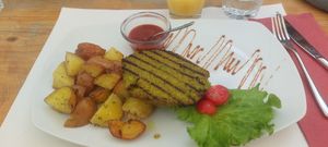 Polenta Peas burger with baked potatoes at Zam Tachji in Alagna Valsesia