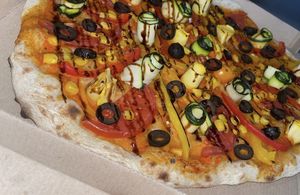 Vegan Marinara pizza: sauce (fresh tomatoes, garlic, fresh oregano, basil, olive oil), tomatoes, bell pepper, zucchini, sweet corn, black olives, balsamic vinegar cream at Crust in Yerevan