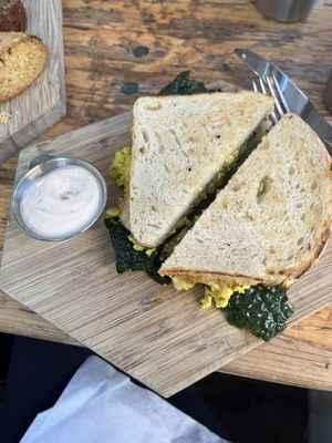 Best egg sandwich (sub sourdough bread, tofu scramble, and vegan cheese); had spicy aioli in the side   at The Butcher's Daughter - Nolita in New York City