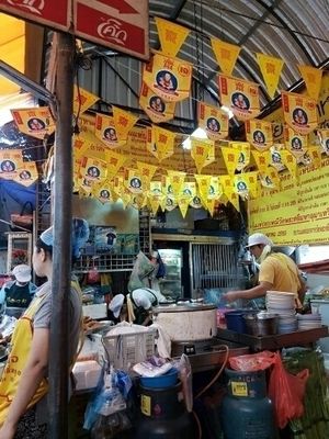 Veggie food stall with yellow flags  at Vegan Thai Food Stalls in Bangkok