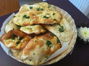 Lavash. Homemade and organic. Middle eastern style bread with crushed sea salt, fresh garlic and fresh basil, drizzled with salsa verde at The Courtyard Cafe in Biggleswade