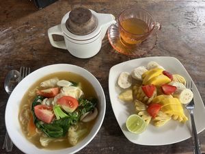 Noodle soup with vegetables, fruit plate and tamarind tea  at Water Castle Cafe in Yogyakarta