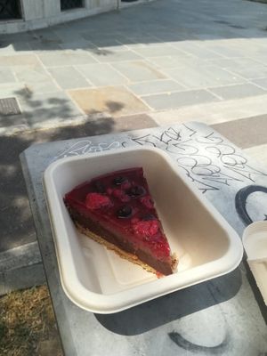 Chocolate and raspberry vegan cheesecake with red fruits at Cuore Verde in Milan